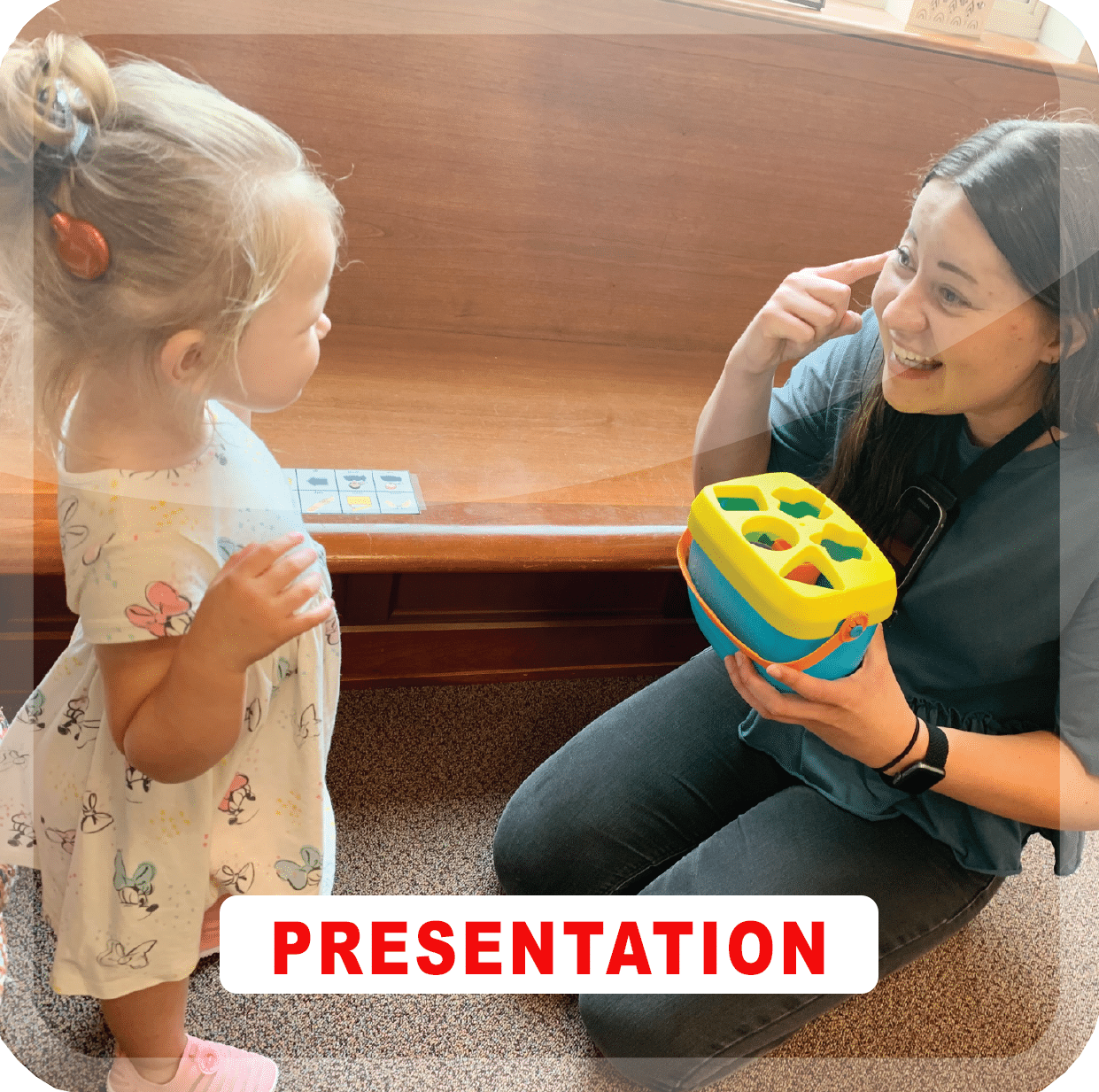 And adult and a child playing with a toy