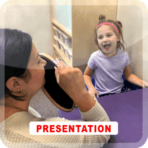 Photograph of an adult and a toddler. the toddler is laughing